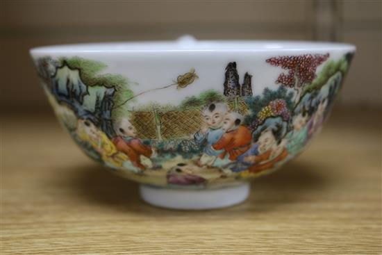 A Chinese porcelain bowl, painted with infants in a landscape, diam. 13.5cm